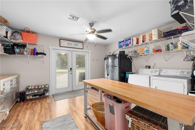 laundry room with ceiling fan, light hardwood / wood-style floors, washer and clothes dryer, and french doors