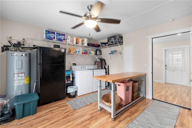 laundry room with light wood-type flooring, ceiling fan, independent washer and dryer, and electric water heater