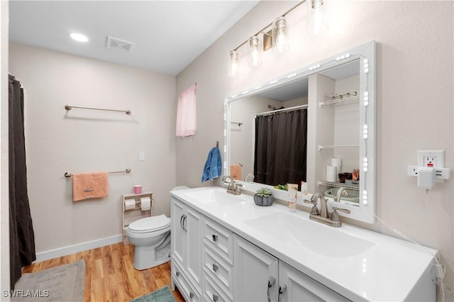 bathroom featuring hardwood / wood-style floors, toilet, and vanity