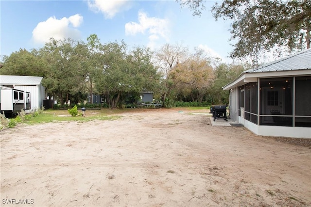 view of yard with a sunroom