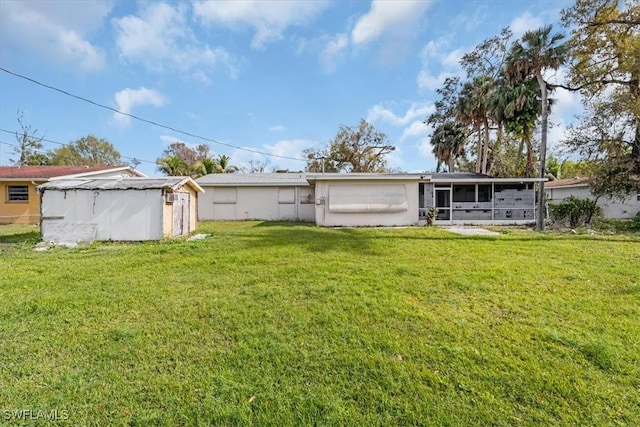 rear view of property with a yard