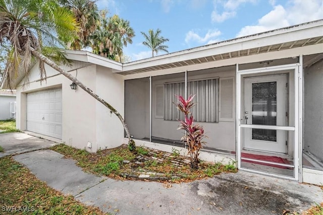 view of exterior entry featuring a garage