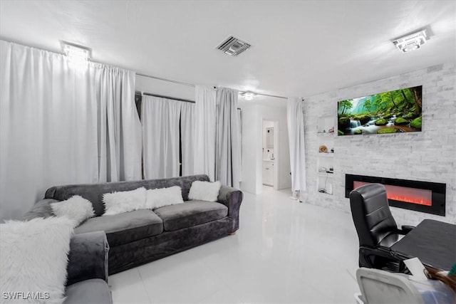 living room with a stone fireplace