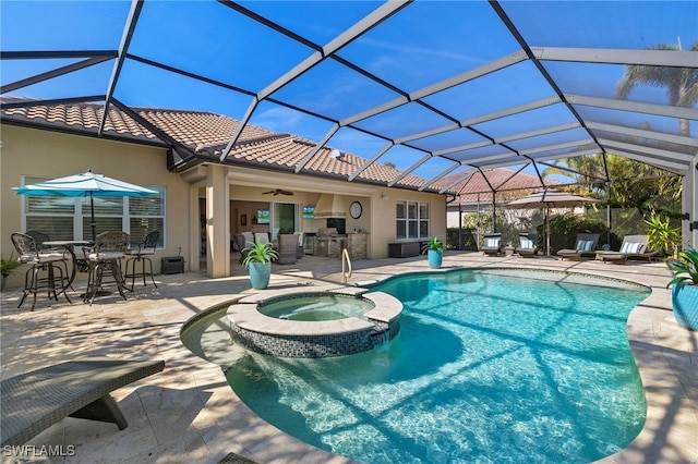 view of pool featuring a patio, exterior bar, an in ground hot tub, and a lanai