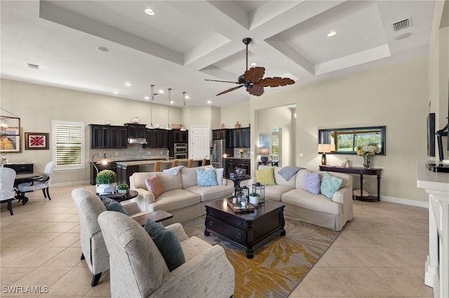 living room featuring coffered ceiling, light tile patterned floors, beamed ceiling, a towering ceiling, and ceiling fan