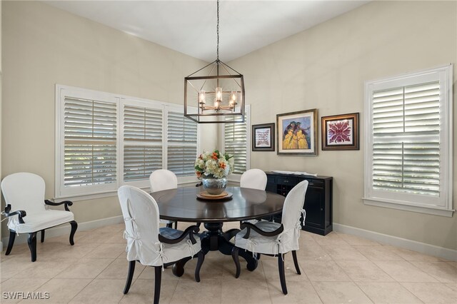 dining room with light tile patterned floors and a chandelier