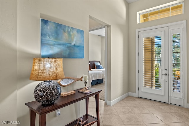 entryway with light tile patterned floors and a wealth of natural light