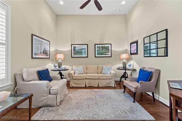 living room with hardwood / wood-style flooring and ceiling fan