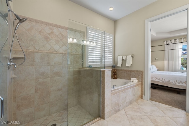 bathroom featuring plenty of natural light, shower with separate bathtub, and tile patterned flooring