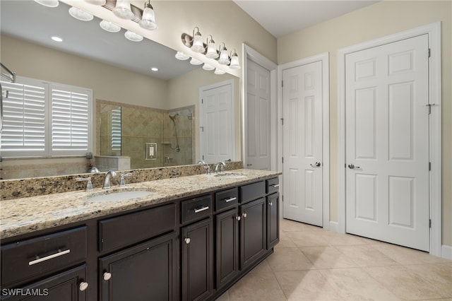 bathroom with vanity, tile patterned floors, and tiled shower