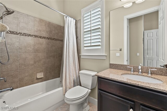 full bathroom with shower / bath combination with curtain, vanity, and toilet