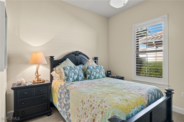 bedroom featuring light colored carpet