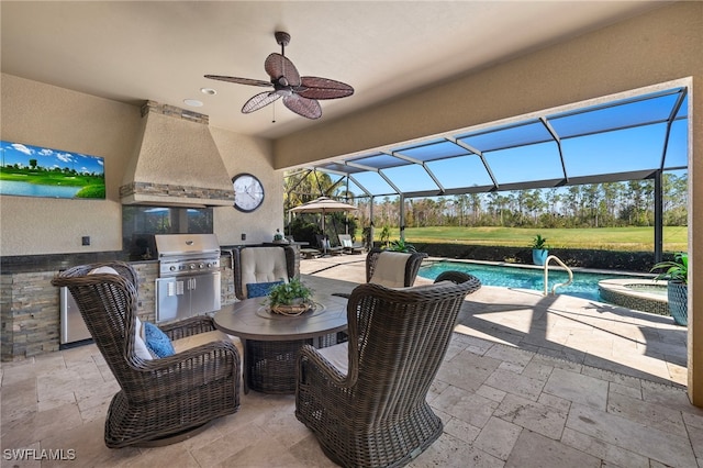 view of patio with area for grilling, glass enclosure, a bar, ceiling fan, and a swimming pool with hot tub