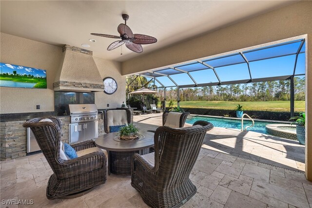 view of patio / terrace with glass enclosure, a bar, a pool with hot tub, ceiling fan, and an outdoor kitchen