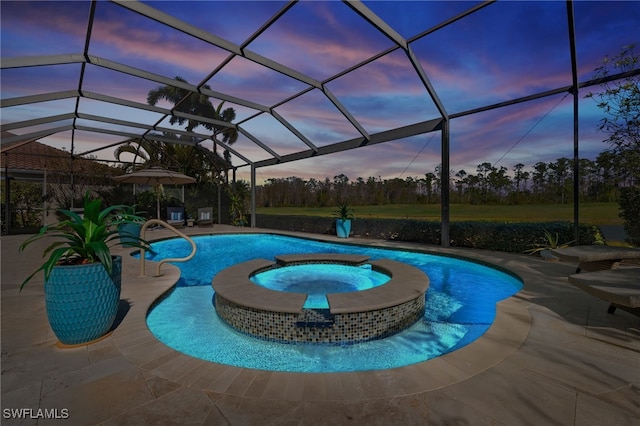 pool at dusk featuring an in ground hot tub, a lanai, and a patio