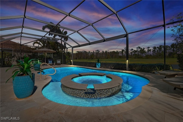 pool at dusk featuring an in ground hot tub, a patio, and glass enclosure