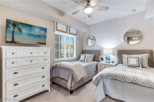 bedroom featuring light carpet and ceiling fan