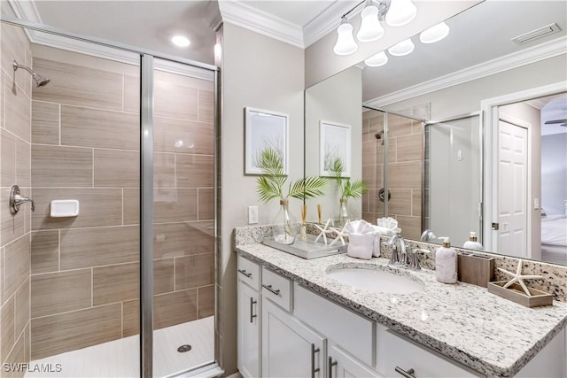 bathroom featuring vanity, ornamental molding, and walk in shower