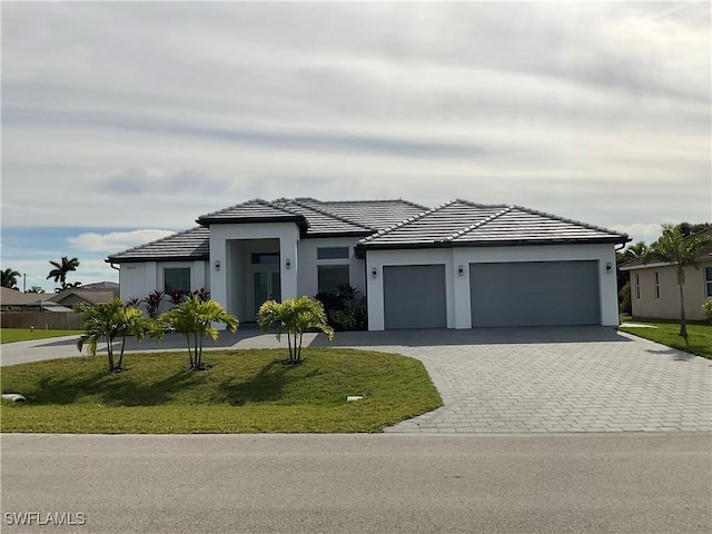 view of front of home with a garage and a front yard