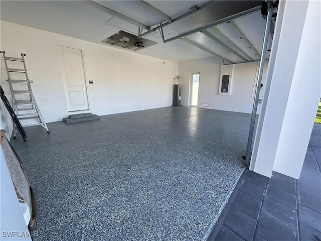 garage featuring electric panel and electric water heater