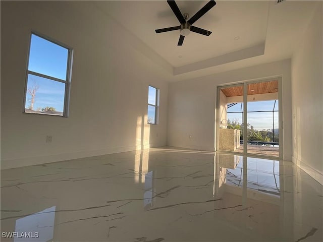 spare room featuring ceiling fan and a tray ceiling