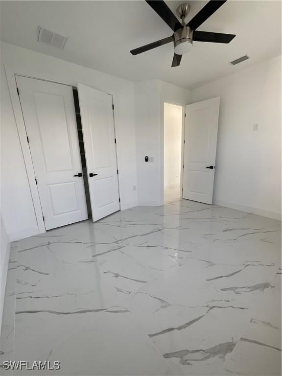 unfurnished bedroom featuring ceiling fan