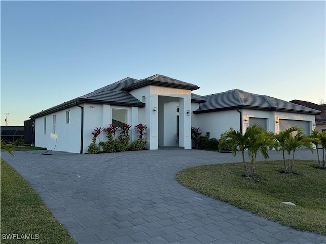 view of front of property with a garage and a front yard