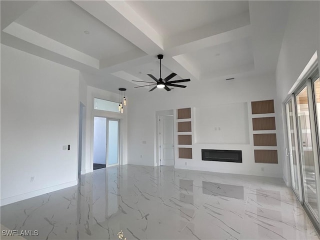 unfurnished living room with coffered ceiling, ceiling fan, beamed ceiling, and a high ceiling