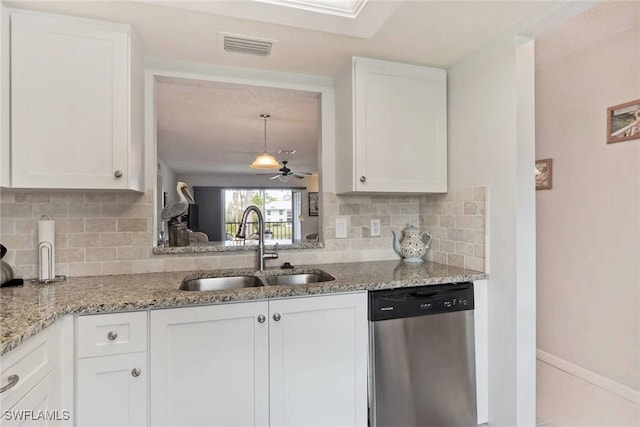 kitchen with tasteful backsplash, dishwasher, white cabinets, light stone counters, and sink