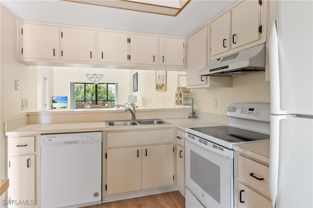 kitchen featuring sink, white appliances, and light hardwood / wood-style flooring