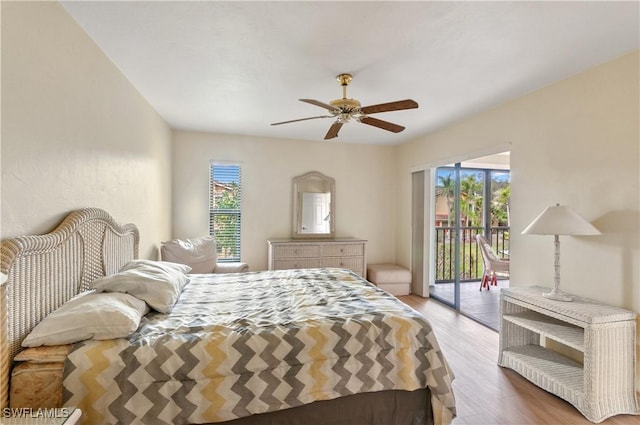 bedroom with hardwood / wood-style floors, ceiling fan, and access to outside