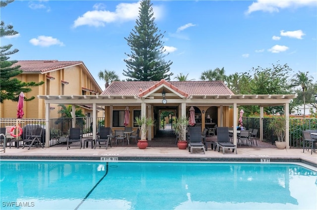 view of pool featuring an outbuilding and a patio area