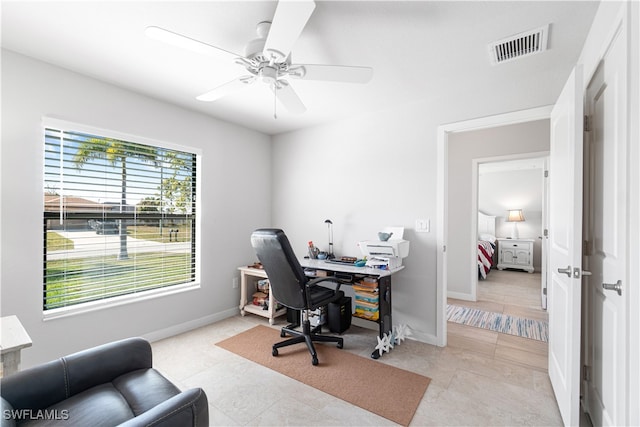 office area featuring ceiling fan, light tile patterned floors, and a healthy amount of sunlight