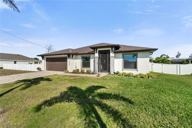 view of front of home with a front yard and a garage