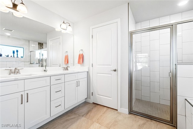 bathroom with walk in shower and vanity