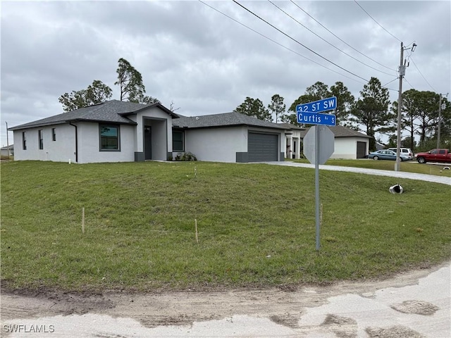 view of front of home with a front yard and a garage