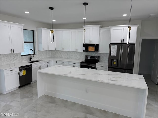 kitchen with hanging light fixtures, white cabinets, black appliances, and a kitchen island