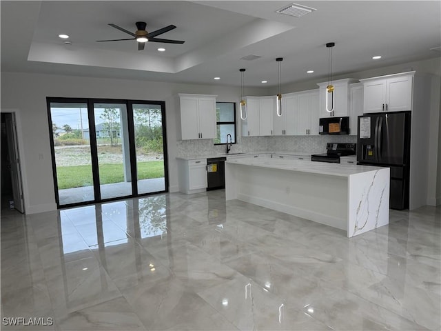 kitchen featuring black appliances, white cabinets, pendant lighting, and a kitchen island