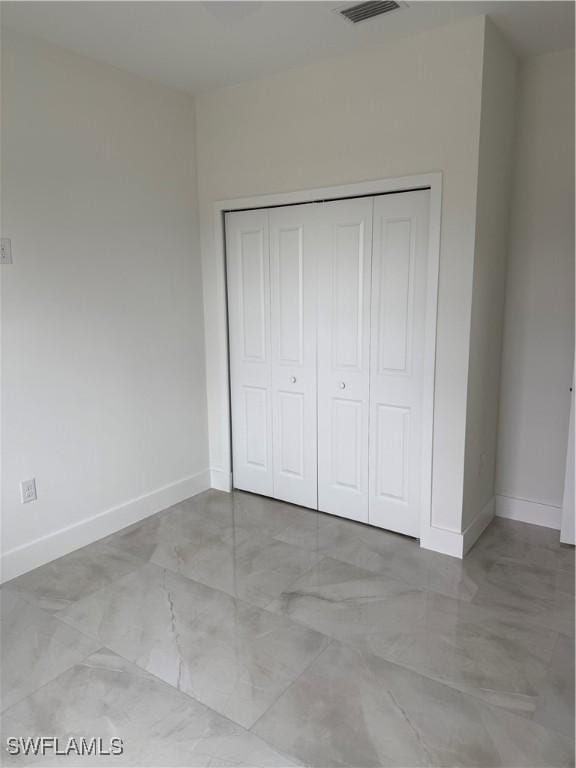 unfurnished bedroom with a closet