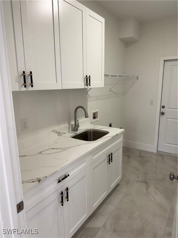 clothes washing area featuring washer hookup, sink, hookup for an electric dryer, and cabinets