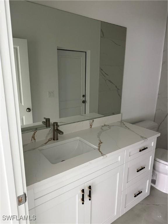 bathroom featuring toilet and vanity