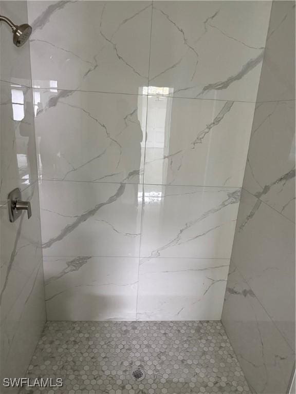 bathroom with tiled shower