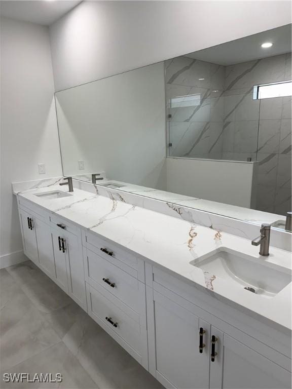 bathroom with tiled shower and vanity