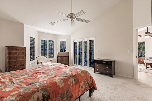 bedroom with ceiling fan, high vaulted ceiling, and light colored carpet