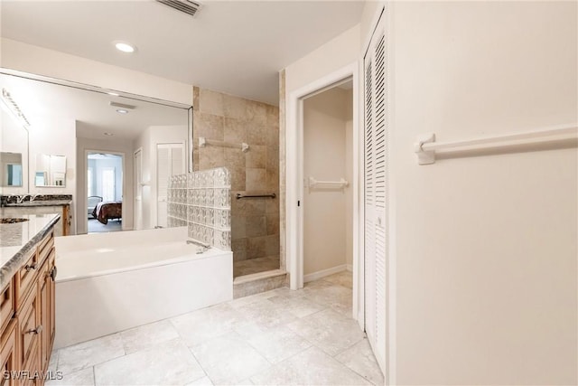 bathroom featuring a closet, visible vents, tiled shower, vanity, and a bath