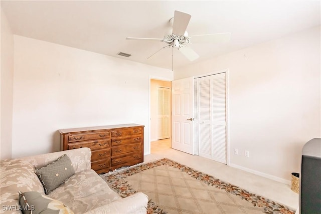 sitting room with ceiling fan, carpet flooring, visible vents, and baseboards