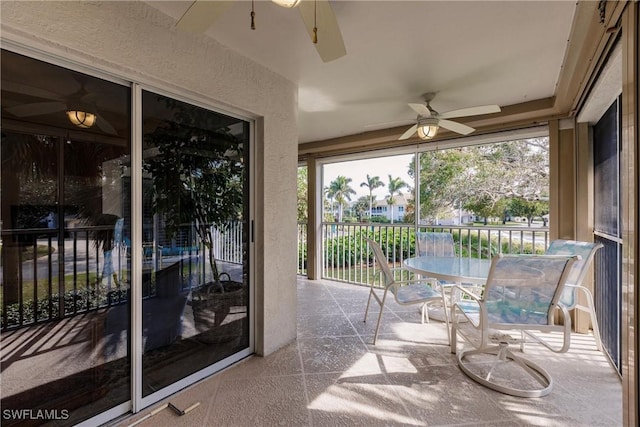 sunroom with a ceiling fan