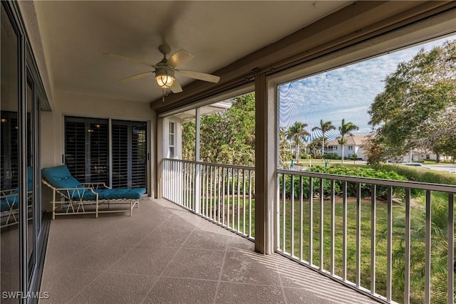 unfurnished sunroom featuring ceiling fan