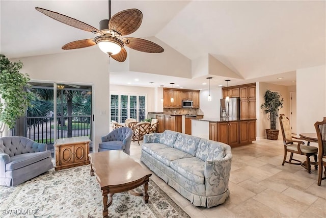 living area featuring high vaulted ceiling, a ceiling fan, and recessed lighting