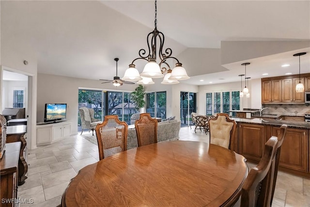 dining room with sink, vaulted ceiling, and ceiling fan